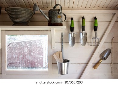 Garden Tools In A Small Storage Shed. Shovels, Rake, Water Pitcher And All You Need For Gardening.