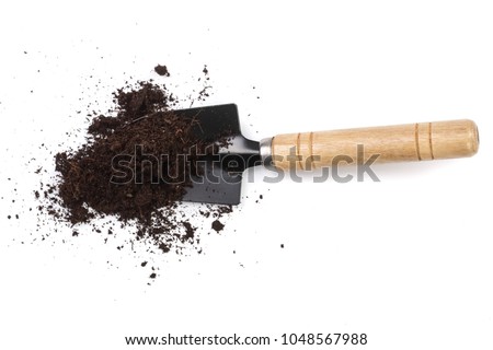 garden tools in soil isolated on white background