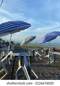 Garden Umbrellas Tilt To The Side As Humming, Strong Winds Hit 