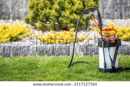 Garden Use Atomizing Backpack Sprayer For Fertilizing Garden Plants. Gardening and Landscaping Equipment Theme.
