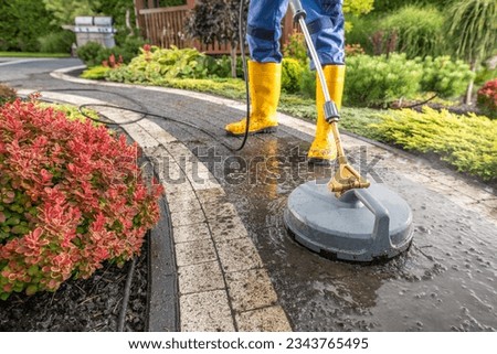 Garden Worker Pressure Washing Decorative Bricks Garden Paths. Garden Keeper Job.