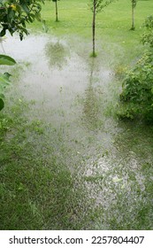 The garden and yard are flooded. Consequences of downpour, flood. Rainy summer. Vertical - Shutterstock ID 2257804407