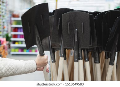 Gardener Is Buying A New Spade In A Garden Store.