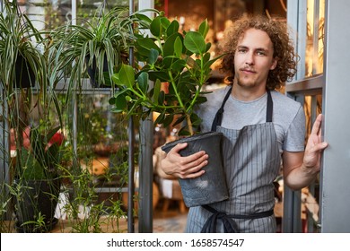 Gardener With Green Plant For Delivery Or For Shipment In The Garden Center