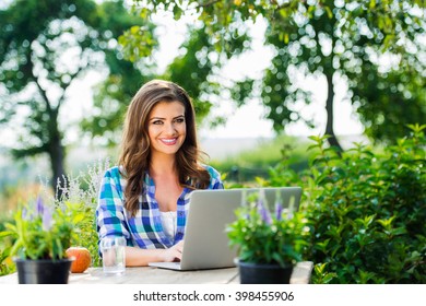 Gardener with notebook, sitting at the table, green nature - Shutterstock ID 398455906