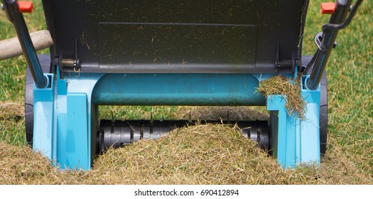 Gardener Operating Soil Aeration Machine On Grass Lawn.