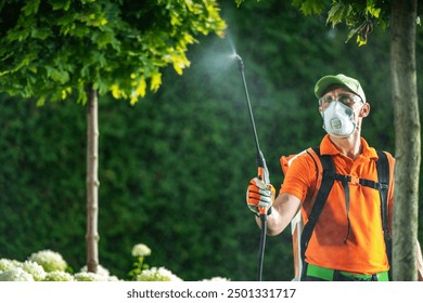 A gardener in an orange shirt and protective gear sprays pesticide on plants, ensuring the health of the garden. - Powered by Shutterstock