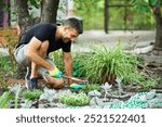 Gardener planting flowers in the garden.