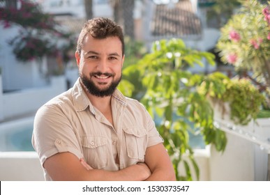 Gardener posing looking at camera in sunny summer day smiling