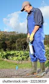 A Gardener  Removing Moss At Paving Stones With Flame Thrower