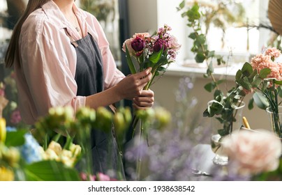 Gardener s in the flower shop make bouquet for a holiday. Lifestyle flower shop. Beautiful flower composition. Detail. Close up - Powered by Shutterstock