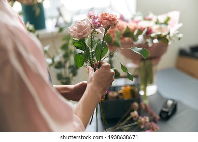 Gardener s in the flower shop make bouquet for a holiday. Lifestyle flower shop. Beautiful flower composition. Detail. Close up. - Powered by Shutterstock