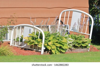 A Gardener With A Sense Of Humor By Using An Old Bed Frame As Part Of Their Landscaping Presentation To Create A 