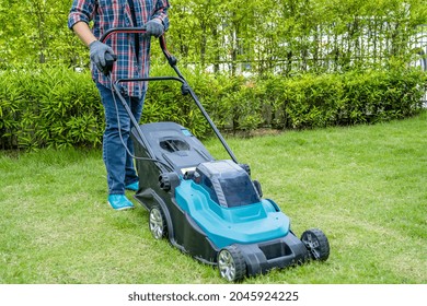 Gardener Use Lawn Mover Machine Cut Green Grass, Hobby Planting Home Garden.