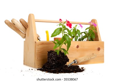 A Gardener's Tote Box On A White Background With Tools, Plants And Gloves