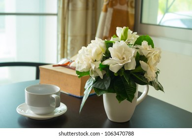 Gardenia Bouquet In Vast And White Coffee Cup Put On Black Table.