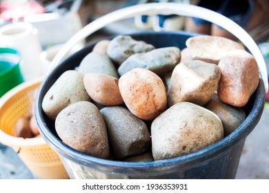 A gardening bucket full of stones