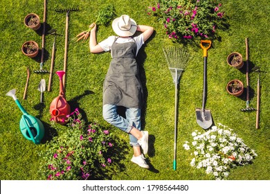 Gardening  Gardener Girl Relaxed Lying  Green Grass, Surrounded Gardening Tools With Plants Workplace home among plants  home garden ,agriculture, freelance, work  home, slow life, mood  - Shutterstock ID 1798564480