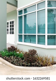 Gardening Idea - Small Front Yard Decorated In Front Of Green House Wall In Vintage Style  ( Green Wall With Green Tinted Glass Hexagon Window (heat Absorbing Glass) With White Frame