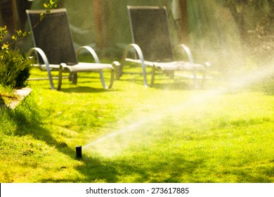 Gardening. Lawn Sprinkler Spraying Water Over Green Grass. Irrigation System - Technique Of Watering In The Garden.