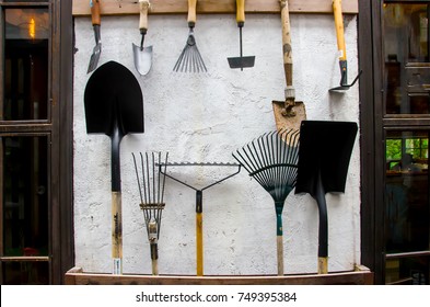 Gardening Tools On Cement Wall - Tool Concept.