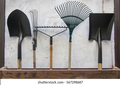 Gardening Tools, Spade, Fork And Rake On Cement Wall ,garden Tools Concept.