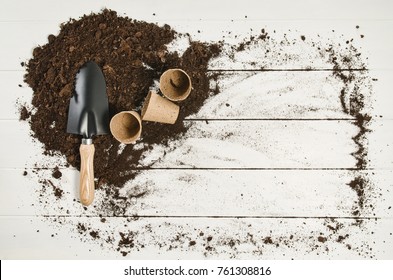 Gardening Tools Top View On White Wooden Planks Background With Copy Space Around Products. Border With Place For Text. Gardening Or Planting Concept Seen From Above. Working In A Clean Indoor Garden.