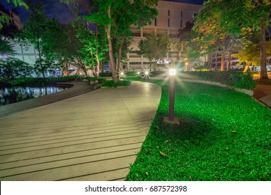 gardens with pathway and lantern that exploded ray light at night
