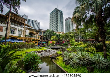 Gardens and skyscrapers at Greenbelt Park, in Ayala, Makati, Metro Manila, The Philippines.