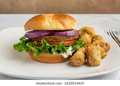 garen veggie burger with lettuce, tomato on a brioche bun served with broccoli tots.