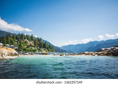 The gargantuan homes of wealthy people line the hills near Deep Cove, a popular sea-kayaking destination near Vancouver, Canada. - Shutterstock ID 1362357149