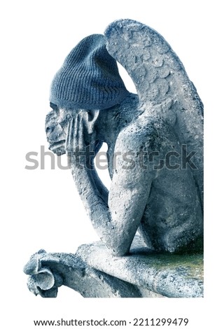 Gargoyle feeling cold isolated on white background, Paris, France. Funny gargoyle (chimera) statue in winter knitted hat. Concept of expensive gas and electricity, energy crisis, travel and weather.