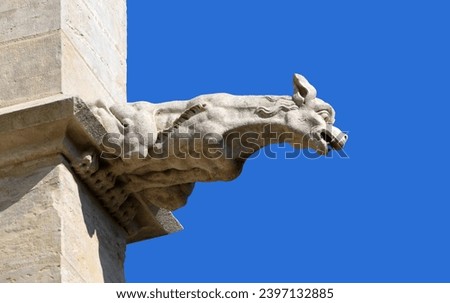 A gargoyle at the French Cathedral isolated on the blue background