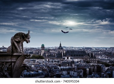 Gargoyle Of Notre Dame De Paris Cathedral Overlooking City At Gothic Night, France. Dark Skyline On Halloween. Fantasy Mystic View Of Haunted Paris At Dusk. Gloomy Panorama Of Old Town In Twilight.