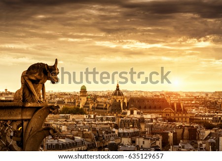 Gargoyle on Cathedral of Notre Dame de Paris overlooking city at sunset, France. Panorama of Paris with old Gothic statue in sunlight. Sunny view of Paris from Notre Dame roof. Dramatic sky background
