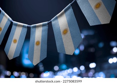 A garland of Argentina national flags on an abstract blurred background. - Powered by Shutterstock