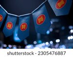 A garland of ASEAN national flags on an abstract blurred background.