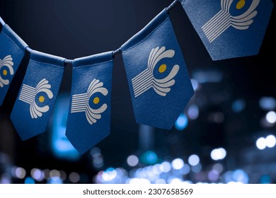 A garland of CIS national flags on an abstract blurred background.