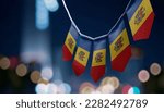 A garland of Moldavia national flags on an abstract blurred background.