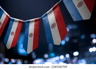 A garland of Paraguay national flags on an abstract blurred background. - Powered by Shutterstock