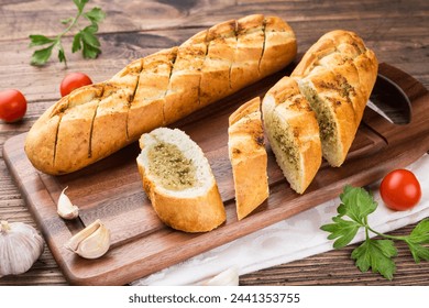 garlic baguette roll on a wooden cutting board - Powered by Shutterstock