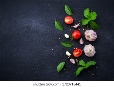 Garlic,  Basil Leaf, Mint Leaf And Tomato On Black Background.