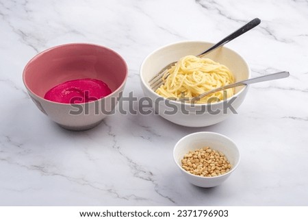 Garlic beetroot sauce, boiled spaghetti or vermicelli and pine nuts. Barbie pasta making kit. Home cooking.