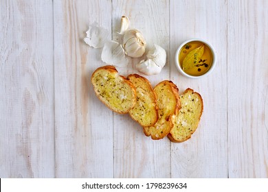 Garlic Bread With Olive Oil, Garlic Cloves And Herbs, Top View