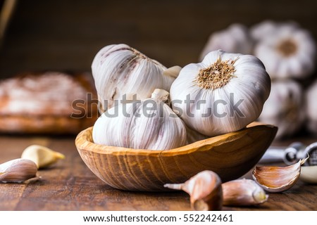 Garlic Cloves and Bulb in vintage wooden bowl.