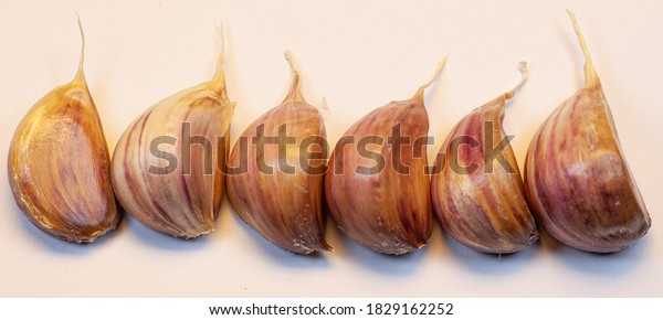 Garlic cloves divided, for strong health,\
virus, white background