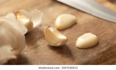 Garlic cloves on a cutting board. Close-up, shallow dof. - Powered by Shutterstock