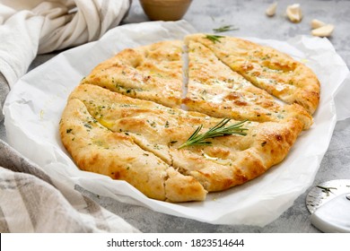 Garlic foccacia bread. Freshly baked flat garlic bread, olive oil and herbs. - Powered by Shutterstock