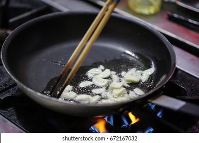  Garlic Is Frying On Pan  With Oil, Garlic With Frying Pan