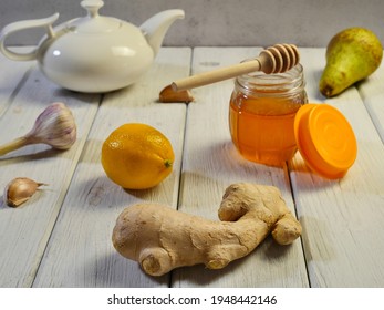 Garlic, ginger, lemon and honey, pear. Vitamins for the prevention of beriberi. Close-up. On white boards. Macrophotography. - Shutterstock ID 1948442146
